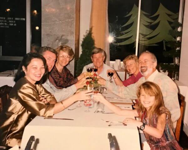 People sitting arond a table toasting