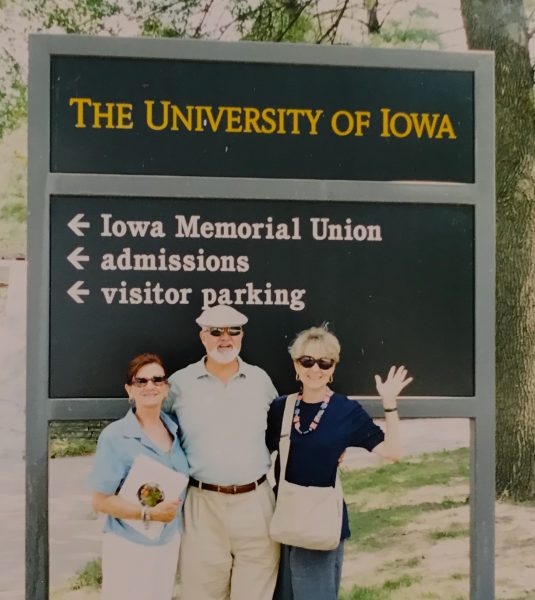 people standing in front of university sign