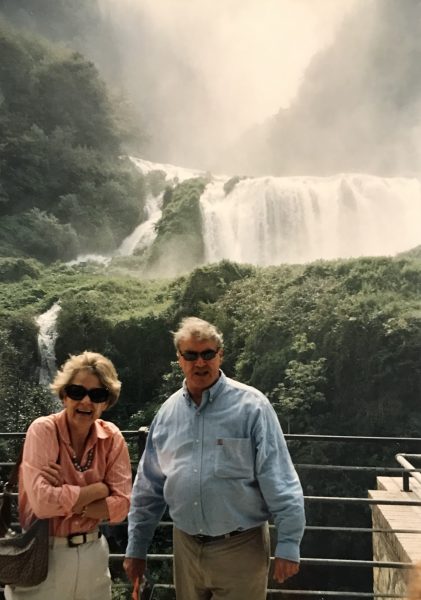 man and woman by a waterfall