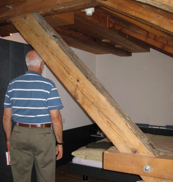 man standing next to a beam